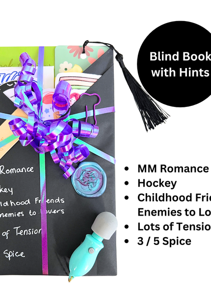 A blind date with a box gift set featuring a black envelope-style box wrapped with a purple and lavender striped ribbon, decorated with a black tassel, a turquoise massage gun, and various colorful inserts. A black circle on the top right reads 'Blind Book with Hints' and a list of topics by the bottom right lists 'MM Romance', 'Hockey', 'Childhood Friends to Enemies to Lovers', 'Lots of Tension', and '3/5 Spice'.